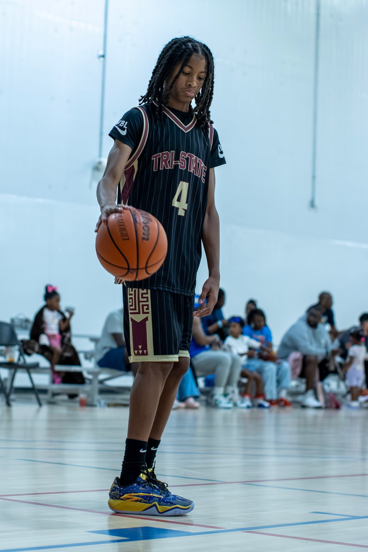 KJ dribbling in a black Tri-State uniform