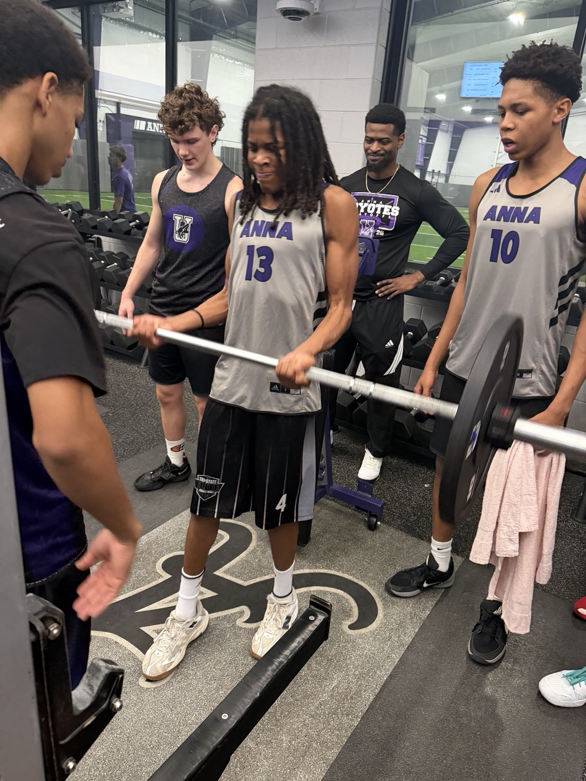 KJ training with weights in his purple and silver Anna basketball uniform